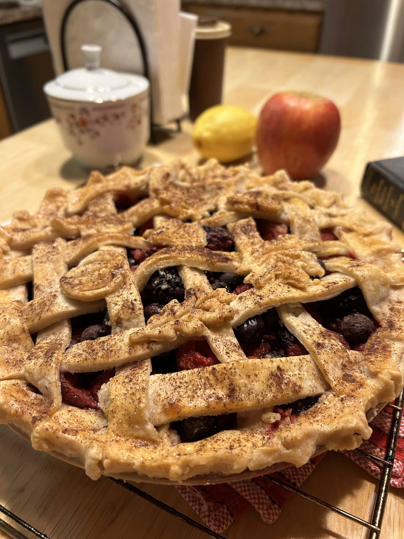 A forest berry pie with lattice top crust sitting on the kitchen island.