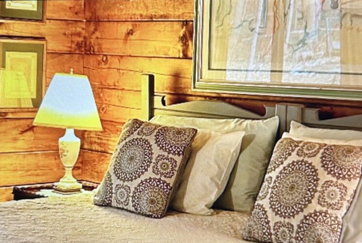 Greylock Room with king size bed and nightstand and lamp.