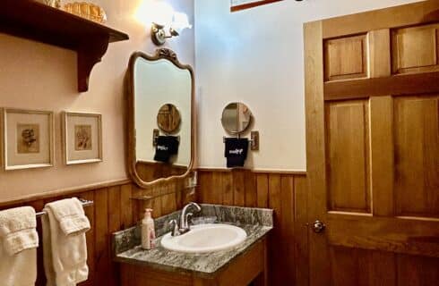 The newly renovated Monument bath has a new vanity with a stone top, new brushed nickel accessories, and a porcelain floor.