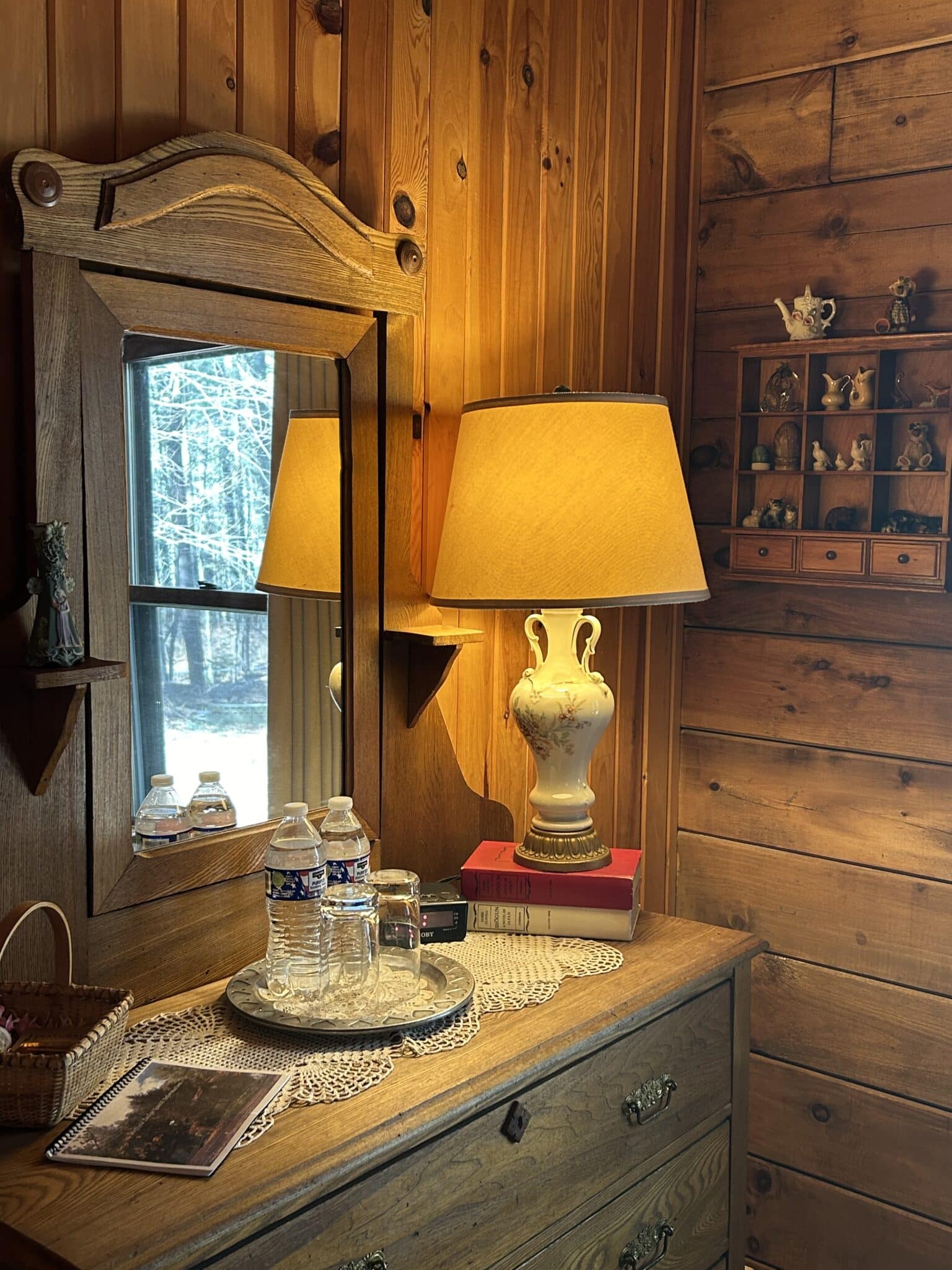 The Monument dresser with a lamp and room amenities.